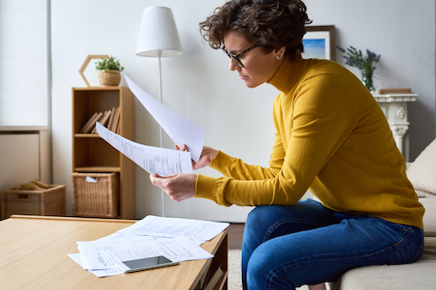 Woman sitting at coffee table doing taxes