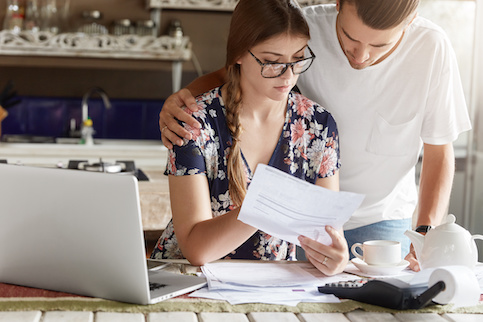 Young couple examining debt.