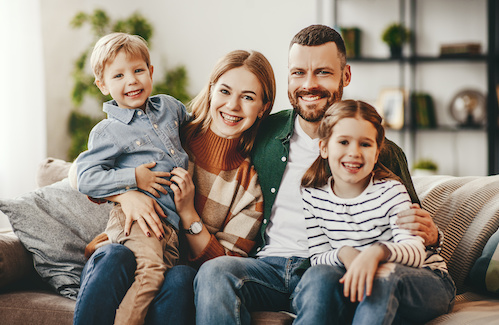 Young, happy family at home together.