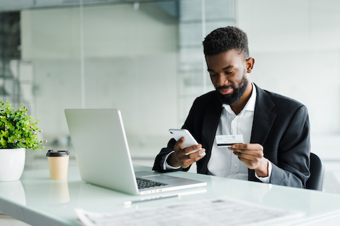 Young man paying by credit card.