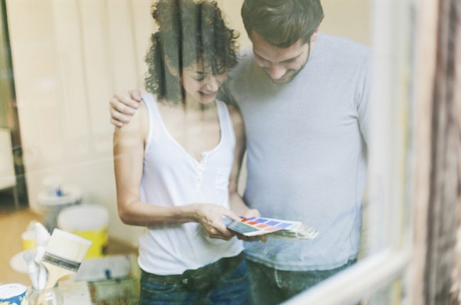 Young couple choosing paint colors together.