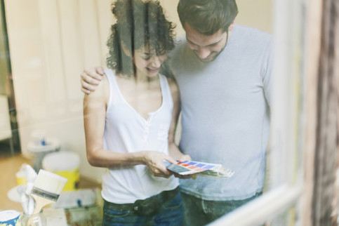 Young couple choosing paint swatches together.