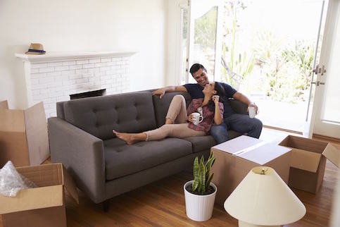 Couple sitting on a couch together.