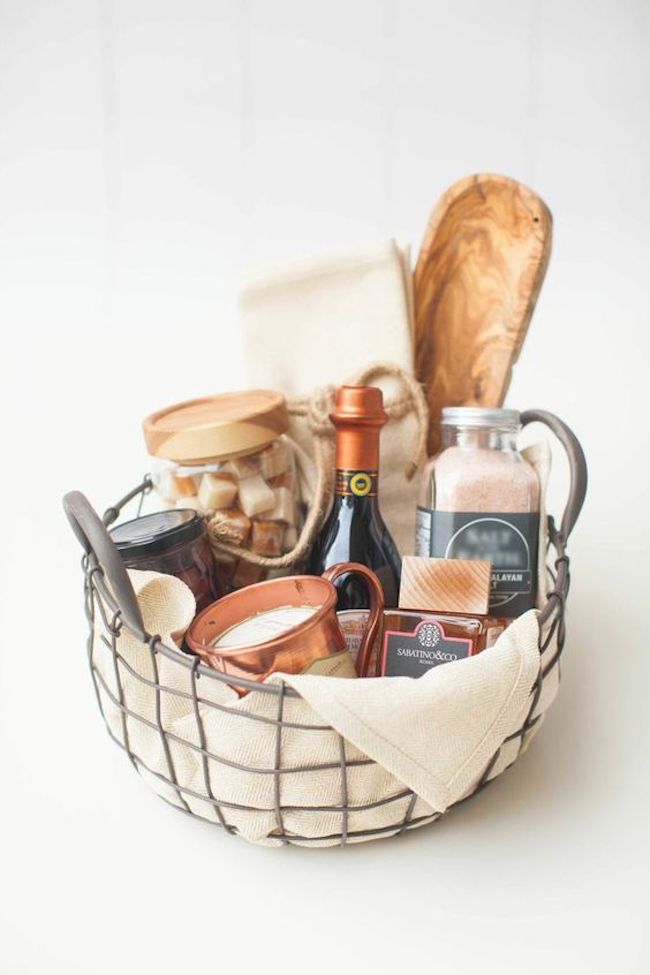 Living room gift basket containing cheeses and oils.
