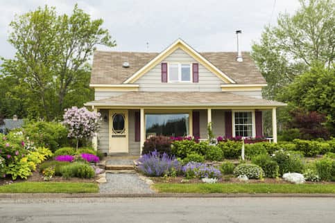 Exterior view of front of home with a thriving garden.