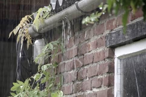 Close up of a leaky gutter on a house.