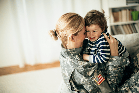 Military mom holding her child.