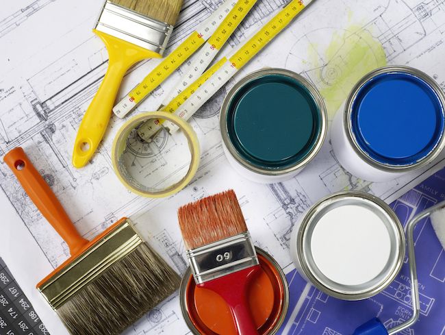 A collection of painting tools, including paintbrushes and paint cans.