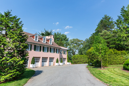 Large pink house surrounded by greenery