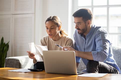 couple doing finances with laptop