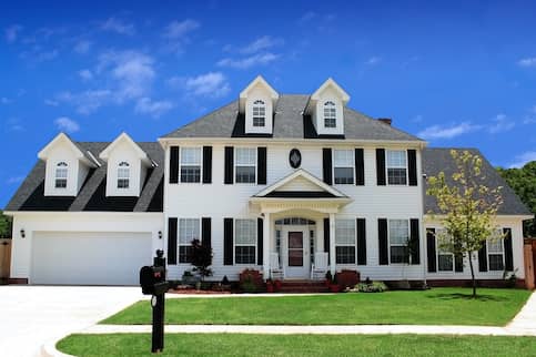 Large two story home with black mailbox.