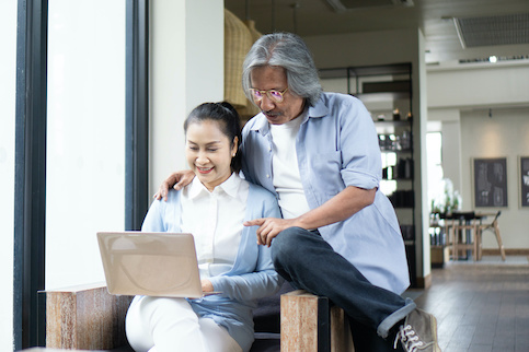 middle aged couple on computer