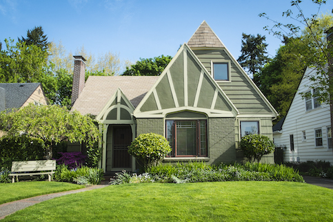 Exterior of a home in a neighborhood with sharp A shaped roofs.