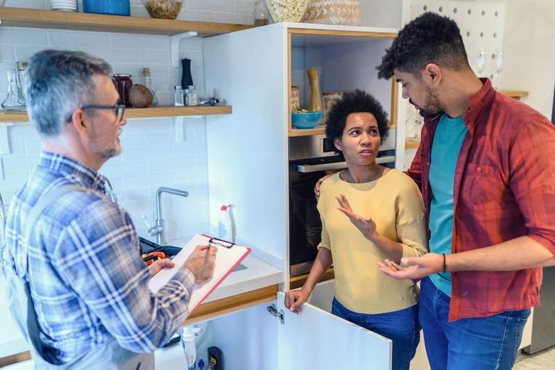 Repairman delivers an estimate to a surprised couple.