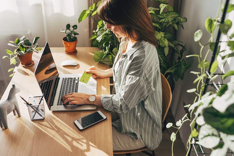 young woman in home filling out a credit card application