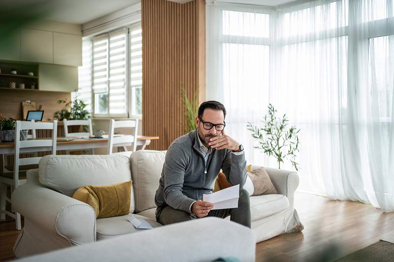Man in his home, worrying about being able to make his next mortgage payment.