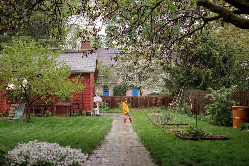 girl plays in front yard