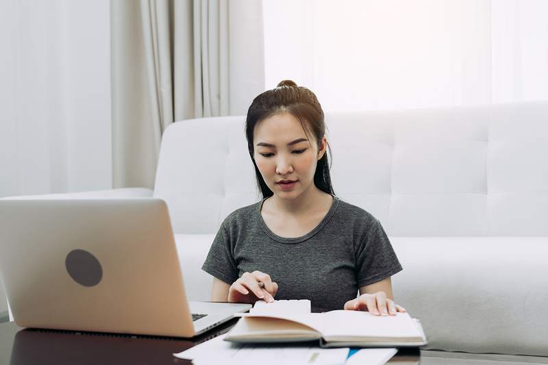 Woman in apartment, saving for down payment on first house.