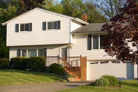 View of a white split-level home from the street.